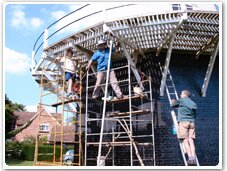 Workers on scaffolding round the mill